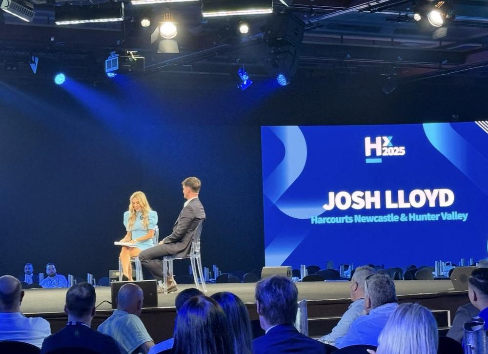 Josh Lloyd on stage at Harcourts HX2025